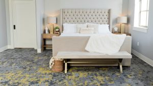 a bedroom with a bed, a bench and a rug at The Discovery Park Life Apartments