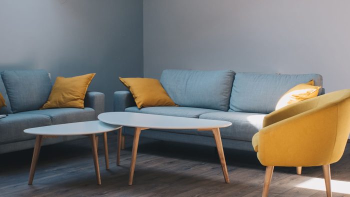 a living room with yellow and blue furniture at The Discovery Park Life Apartments